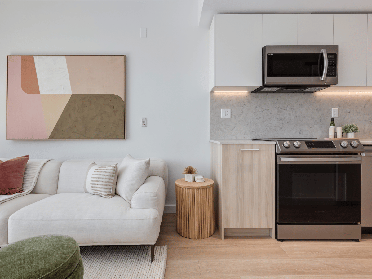 Open-concept kitchen and living room in a suite at Lonsdale Square Apartments.